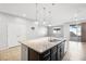 Modern kitchen island with granite countertops and dark cabinetry at 391 Mano Destra Ln, Henderson, NV 89011