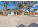 Single story house with gravel landscaping and palm trees at 2606 Vegas Valley Dr, Las Vegas, NV 89121