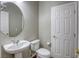 Neat bathroom with a pedestal sink and toilet at 11837 Luna Del Mar Ln, Las Vegas, NV 89138