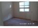 Simple bedroom with pink carpet and a window at 7621 Ribbon Rock Ct, Las Vegas, NV 89139