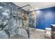 Bathroom with a walk-in shower, marble tile, and blue walls at 3362 Brookfield Dr, Las Vegas, NV 89120