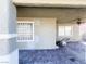 Covered patio with tiled floor, glass block window, and a lawnmower at 4852 Yuma Ave, Las Vegas, NV 89104