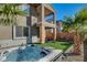 Hot tub and backyard with artificial turf and a view of the house at 49 Strada Moscato, Henderson, NV 89011