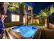 Relaxing hot tub in backyard oasis with palm trees at 49 Strada Moscato, Henderson, NV 89011