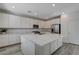 Modern kitchen featuring white cabinets, a large island, and stainless steel appliances at 49 Strada Moscato, Henderson, NV 89011