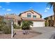 Two-story house with a two-car garage and desert landscaping at 2024 Shadow Brook Way, Henderson, NV 89074