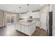 Eat-in kitchen with granite countertops and white cabinetry at 7051 Denio Island St, North Las Vegas, NV 89084