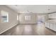 Large living room featuring wood-look floors and lots of natural light at 7051 Denio Island St, North Las Vegas, NV 89084