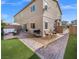 Virtually staged backyard patio with seating and grill at 7051 Denio Island St, North Las Vegas, NV 89084