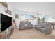 Relaxing living room featuring a sectional sofa and large TV at 8830 Roadrunner Ravine St, Las Vegas, NV 89166