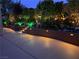 Landscaped backyard with fountain and steps at night at 17 Chatmoss Rd, Henderson, NV 89052