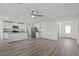 Open living room with kitchen island and vinyl plank flooring at 4231 Gold Desert St, North Las Vegas, NV 89032