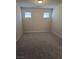 Spacious bedroom with neutral walls and grey carpeting at 3816 Seyfert Ave, North Las Vegas, NV 89084