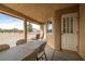 Covered patio with table and chairs, overlooking the backyard at 891 Indole St, Pahrump, NV 89048