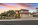 Two-story home with a three-car garage and attractive landscaping at 2917 Whalers Cove Cir, Las Vegas, NV 89117