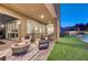 Evening view of backyard patio with firepit, seating area, and string lights at 6411 Wild Blue Ct, Las Vegas, NV 89135