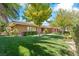 Ranch-style home with brick exterior and lush green lawn at 3841 Hildebrand Ln, Las Vegas, NV 89121