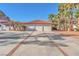 Three-car garage with Spanish-style tile roof and brick driveway at 2868 Vista Del Sol Ave, Las Vegas, NV 89120