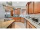 Kitchen boasts granite countertops and wood cabinets at 9209 Dalmahoy Pl, Las Vegas, NV 89145