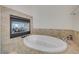 Relaxing bathroom with a jetted tub and fireplace at 9209 Dalmahoy Pl, Las Vegas, NV 89145