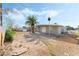 Large backyard with covered patio and gravel landscaping at 1836 Kenneth St, North Las Vegas, NV 89030