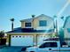 Two-story house with a three-car garage and solar panels at 923 Royalmile Way, North Las Vegas, NV 89032