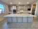 Modern kitchen with large island and white quartz countertops at 9398 Ara Place, Las Vegas, NV 89143