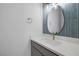 Modern bathroom with blue tile, white vanity, and gold fixtures at 2230 Pigeon Hawk St, Las Vegas, NV 89138