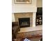 Living room fireplace with granite surround and tile hearth at 122 Broken Putter Way, Las Vegas, NV 89148