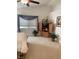 Bedroom featuring a bed, wooden cabinet, and potted plants at 122 Broken Putter Way, Las Vegas, NV 89148