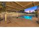 Covered patio area with a sparkling blue pool and spa at 527 Leap Frog Ave, Las Vegas, NV 89183