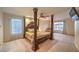 Spacious bedroom with a large four poster bed and a sitting area at 527 Leap Frog Ave, Las Vegas, NV 89183