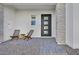 Modern front entry with stone accents and seating area at 10167 Bismarck Palms Ave, Las Vegas, NV 89166