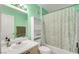 Simple bathroom with a mint green vanity and shower at 7705 Allano Way, Las Vegas, NV 89128