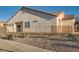 Exterior view of a tan house with rock landscaping at 928 Crescent Falls St, Henderson, NV 89011