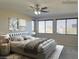 Virtually staged main bedroom with large windows at 9720 Pan Falls St, Las Vegas, NV 89178