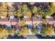 Aerial view of houses with brown tile roofs and lush green trees at 2904 Linkview Dr, Las Vegas, NV 89134