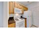 Clean kitchen featuring white appliances and wood cabinets at 7147 S Durango Dr # 111, Las Vegas, NV 89113