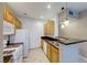 Well-equipped kitchen featuring wood cabinets and granite countertops at 7147 S Durango Dr # 111, Las Vegas, NV 89113