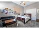 Bedroom with a dark wood bed frame and a black couch at 4996 Del Pueblo Ave, Las Vegas, NV 89141