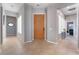 Bright and spacious entryway with tile floors and a modern wood door at 4996 Del Pueblo Ave, Las Vegas, NV 89141