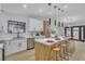 Modern kitchen with island, stainless steel appliances, and light wood cabinets at 3119 Trueno Rd, Henderson, NV 89014