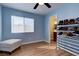 Light blue bedroom with wood floors and built-in shelving at 1508 Splinter Rock Way, North Las Vegas, NV 89031