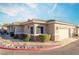 Tan two-story home with attached garage and landscaping at 2285 Canyon Song Ave, Laughlin, NV 89029