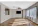 Living room with hardwood floors, ceiling fan, and large windows at 3313 Brambling Ave, North Las Vegas, NV 89084