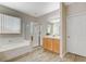 Bathroom with soaking tub, shower, and wood cabinets at 3313 Brambling Ave, North Las Vegas, NV 89084