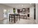 Modern kitchen with island, dark cabinetry, and breakfast bar at 132 Dunblane St, Henderson, NV 89012