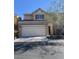 Two story house with a beige exterior and a two car garage at 7984 Dardanelle Valley St, Las Vegas, NV 89139