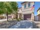 Front exterior of a two-story house with a two-car garage and landscaping at 10028 Sharp Ridge Ave, Las Vegas, NV 89149