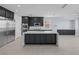 Modern kitchen with dark cabinets, large island with marble countertop, and stainless steel appliances at 10028 Sharp Ridge Ave, Las Vegas, NV 89149